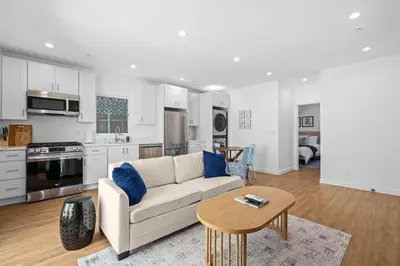 a living room with a couch and a table at Spanish Style Guesthouse Unit 1 in Los Angeles
