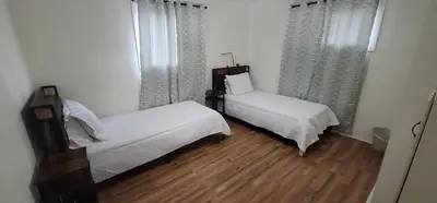 a bedroom with two beds and a window at Private 3 bedroom Home in Los Angeles - Gardena, California in Gardena