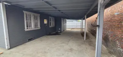 a dark blue house with a cat sitting in a hallway at Private 3 bedroom Home in Los Angeles - Gardena, California in Gardena
