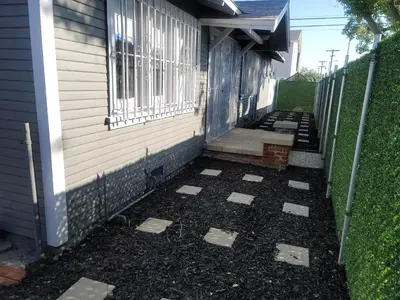 a walkway next to a house with a fence at Private 3 bedroom Home in Los Angeles - Gardena, California in Gardena