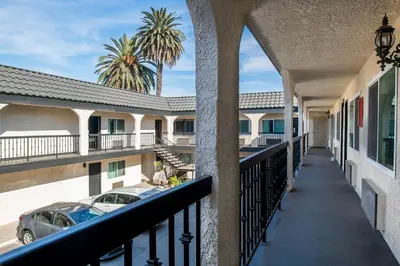 a balcony with a view of a parking lot at La Mirage Inn - Long Beach in Long Beach