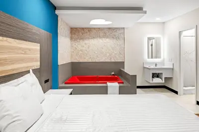 a bedroom with a red tub and a sink at La Mirage Inn - Long Beach in Long Beach