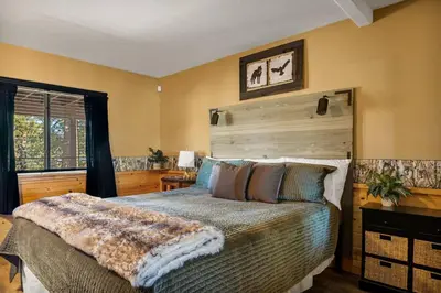 a bedroom with a large bed and a window at Its a Wonderful Lodge in Big Bear Lake