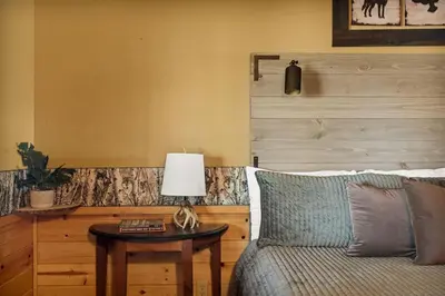 a living room with a couch and a table with a lamp at Its a Wonderful Lodge in Big Bear Lake
