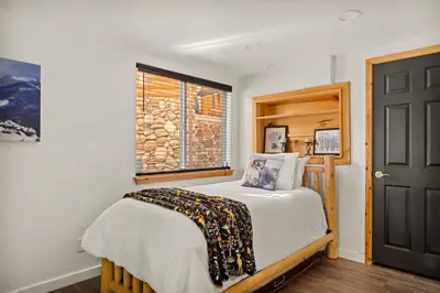 a bedroom with a bed and a window at Its a Wonderful Lodge in Big Bear Lake