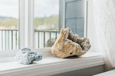 a window sill with a rock and a stuffed animal at Off The Hook in Big Bear Lake in Big Bear Lake