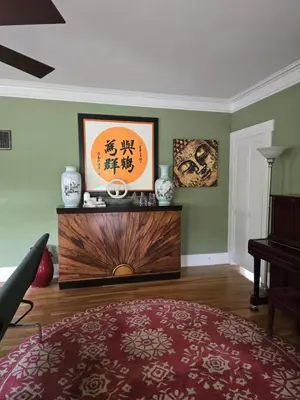 a living room with a table and a piano at The Ginkgo House in Pasadena