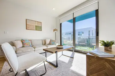 a living room with a couch and a table at Beachside 2BD 2BA, 12Min Walk to Santa Monica Pier in Los Angeles