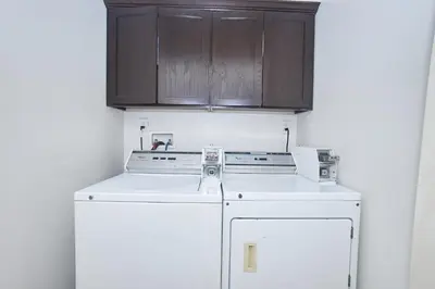 a kitchen with a white refrigerator and wooden cabinets at Blue Private Room near BMO Stadium USC and K-Town in Los Angeles