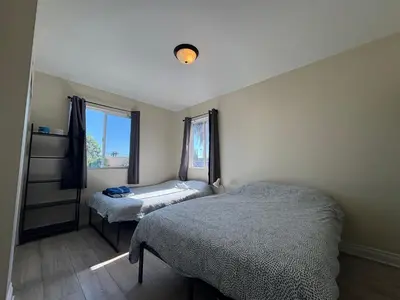 a bedroom with two beds and a window at Blue Private Room near BMO Stadium USC and K-Town in Los Angeles