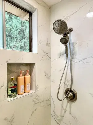 a shower in a bathroom with a shower head at Fire Support 3Bedroom Modern Luxury House in Central Pasadena in Pasadena