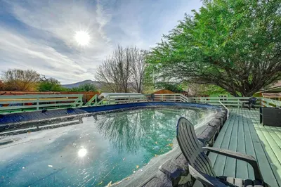 a swimming pool with a wooden deck and a chair at Mtn-View Weldon Home Walk to Pacific Crest Trail in Weldon