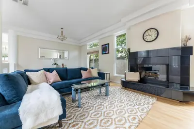 a living room with a blue couch and a fireplace at Tranquil family beach city retreat in Redondo Beach