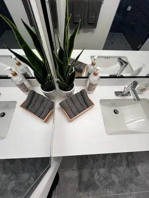 a bathroom with two sinks and plants on a counter at Heart of Hollywood-Walk of Fame 1bd Studio with View -Free parking, balcony, wifi, rooftop, gym, upscale amenities in Los Angeles