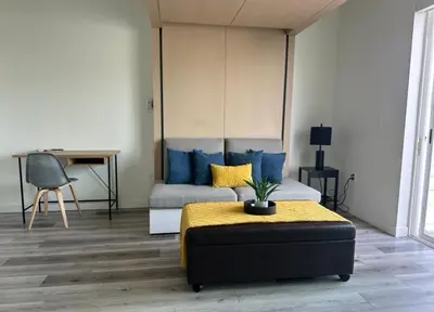 a living room with a bed and a desk at Heart of Hollywood-Walk of Fame 1bd Studio with View -Free parking, balcony, wifi, rooftop, gym, upscale amenities in Los Angeles