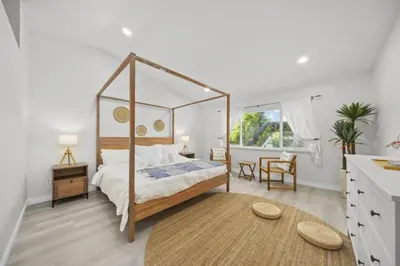 a bedroom with a canopy bed and a table at Luxe Sundance Villa 3BR with Pool and Spa Near Disney in Pomona