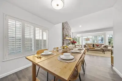 a dining room with a wooden table and chairs at Luxe Sundance Villa 3BR with Pool and Spa Near Disney in Pomona
