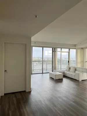 a living room with two white couches and a large window at HollywoodNorth in Los Angeles