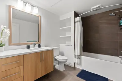 a bathroom with a sink and a toilet and a shower at Amethyst Horizon - Stylish peaceful 2BR w zen Garden View Pool Gym in Los Angeles