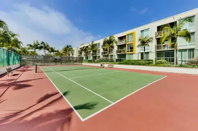 a tennis court in front of a building at Amethyst Horizon - Stylish peaceful 2BR w zen Garden View Pool Gym in Los Angeles