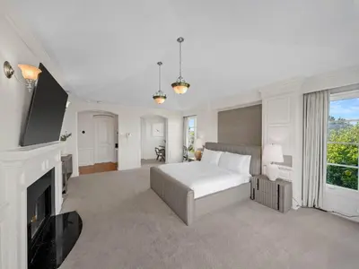 a white bedroom with a bed and a fireplace at Savona Sanctuary Estate in Los Angeles