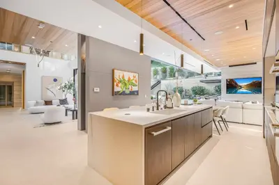 a kitchen with a sink and a living room at Hutton Modern in Beverly Hills