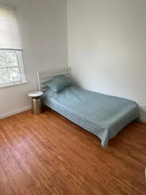 a bed in a room with a wooden floor at Cute room in best area of Hollywood in Los Angeles