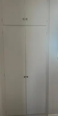 a white cabinet with four doors on a wall at Cute room in best area of Hollywood in Los Angeles