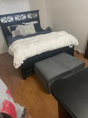 a bedroom with a bed and a foot stool at Sofi Intuit Forum Vacation Oasis in Los Angeles