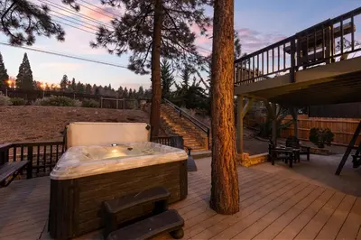 a hot tub on a deck with a tree at NEW Serenity Lodge Base Of Snow Summit Hot Tub in Big Bear Lake