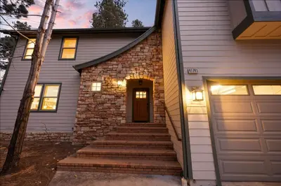 a house with stairs leading to a door at NEW Serenity Lodge Base Of Snow Summit Hot Tub in Big Bear Lake