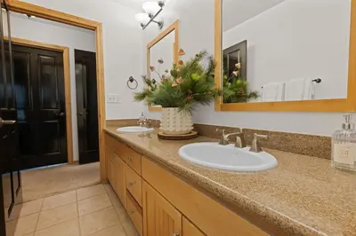a bathroom with two sinks and a mirror at NEW Serenity Lodge Base Of Snow Summit Hot Tub in Big Bear Lake