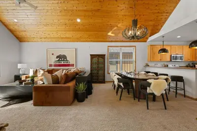 a living room with a couch and a table at NEW Serenity Lodge Base Of Snow Summit Hot Tub in Big Bear Lake