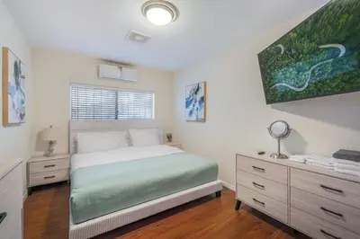 a bedroom with a bed and a dresser in it at Newly Renovated Home Spacious Close 2 Hospital in San Bernardino