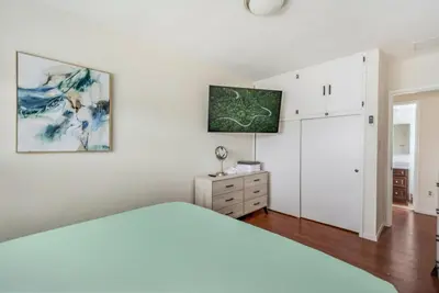 a white bedroom with a bed and a dresser at Newly Renovated Home Spacious Close 2 Hospital in San Bernardino