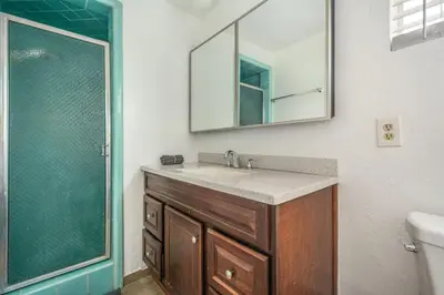 a bathroom with a sink and a mirror and a shower at Newly Renovated Home Spacious Close 2 Hospital in San Bernardino