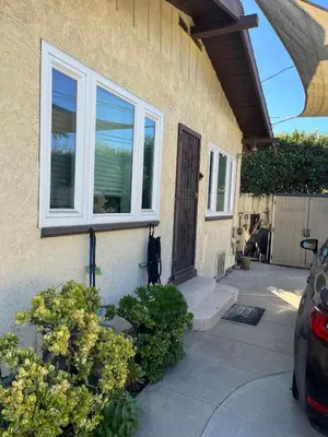 a front door of a house with a car parked outside at Cozy One Bedroom Apartment in Los Angeles