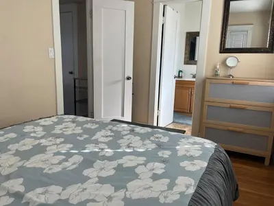 a bedroom with a bed with a blue blanket with flowers at Cozy One Bedroom Apartment in Los Angeles