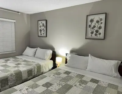 a bedroom with two beds and a window at Beverly Hills Charm Rodeo Cedar in Los Angeles