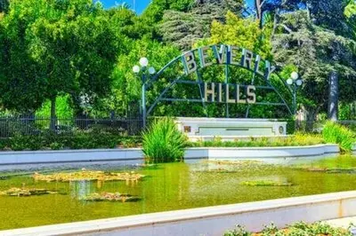 a sign over a pond in a park at Beverly Hills Charm Rodeo Cedar in Los Angeles