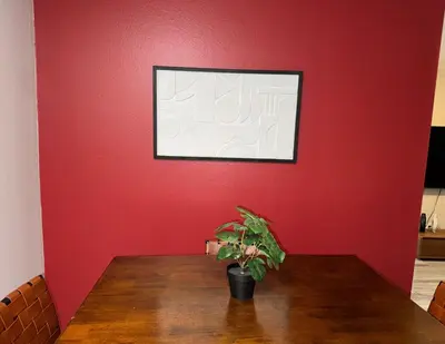 a red wall with a table with a plant on it at Beverly Hills Charm Rodeo Cedar in Los Angeles