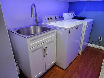 a small kitchen with a sink and a counter at 3 bedroom guest suite first floor unit with nice patio area right next to the MrC Hotel 10 minutes from Rodeo Drive Washer Dryer WIFI and more in Los Angeles