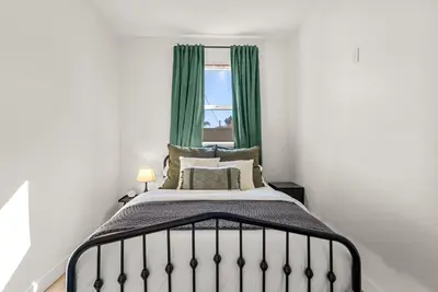 a bedroom with a bed with green curtains and a window at Perfect 2BR Near Universal Studios By Poshguest in San Fernando