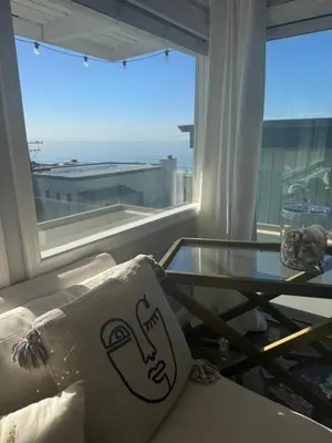 a living room with a glass table and a couch at Manhattan Beach Oasis in Manhattan Beach