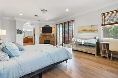 a bedroom with a large bed and a desk at Los Angeles Large Mediteranian Vacation Home in Sherman Oaks Community Hospital Heliport