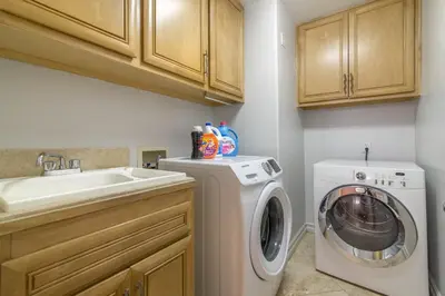 a small kitchen with a washing machine and a sink at Los Angeles Large Mediteranian Vacation Home in Sherman Oaks Community Hospital Heliport