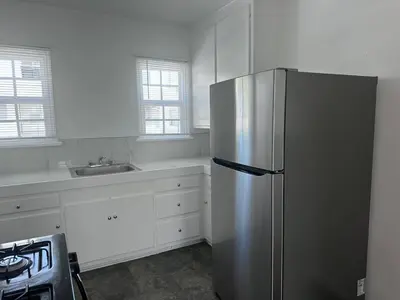 a kitchen with a stainless steel refrigerator and a sink at Best location of Hollywood, great room in 2bdrm apt, walk of fame in Los Angeles