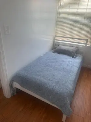 a bed with a blue blanket and a window at Best location of Hollywood, great room in 2bdrm apt, walk of fame in Los Angeles