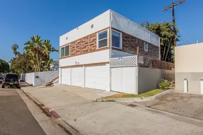 a white and brick house on a street at West LA Chariton in Los Angeles
