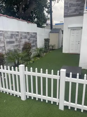 a white picket fence in front of a yard at West LA Chariton in Los Angeles